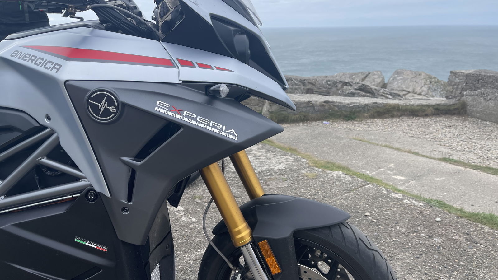 An electric motorcycle looks out to sea